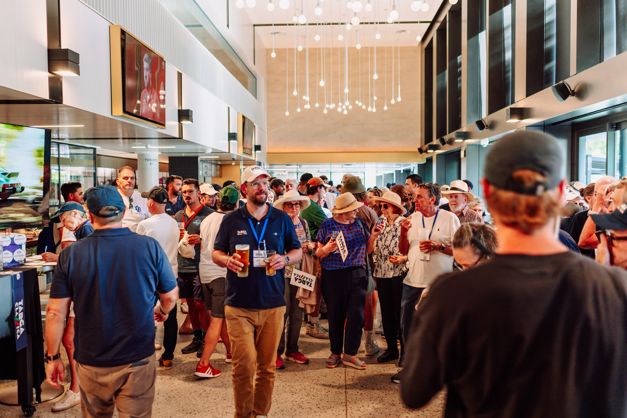 Entrants with drinks in hand at a busy indoor event function