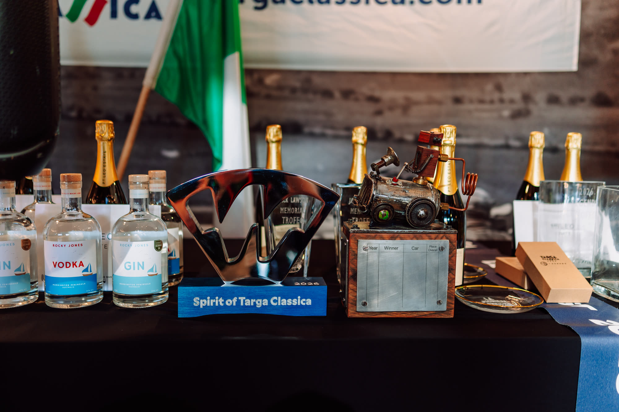 Trophies, glassware and champagne set out on a presentation table