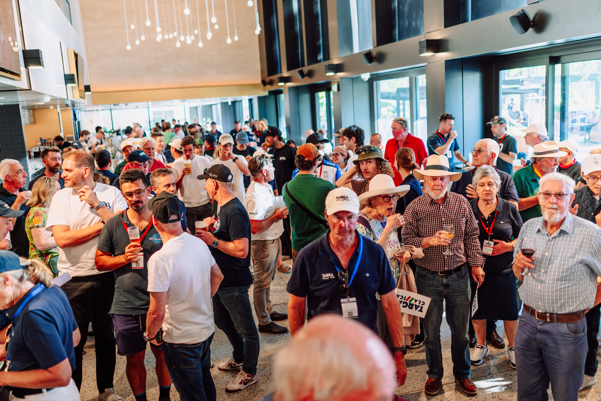 A crowded room of entrants and guests talking over drinks